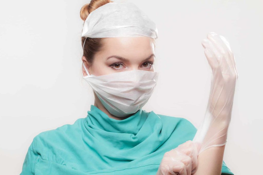 doctor putting on glove victim of medical malpractice
